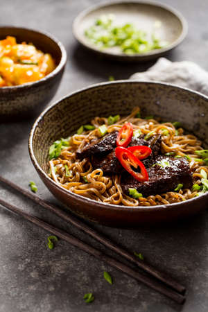 Soba noodles with beef and chopsticksの写真素材