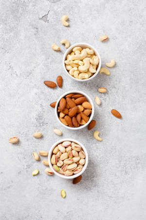 Organic nuts, almonds, cashew, pistachio in a bowls, delicious snack Top viewの写真素材