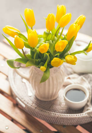 Yellow tulips and fresh teaの写真素材