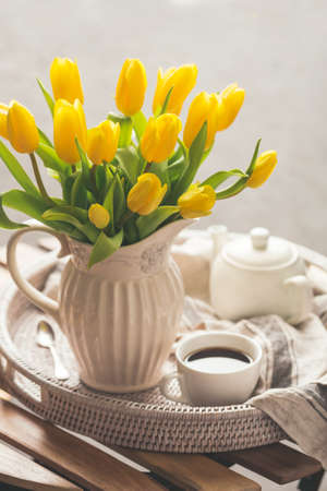 Yellow tulips and fresh teaの写真素材