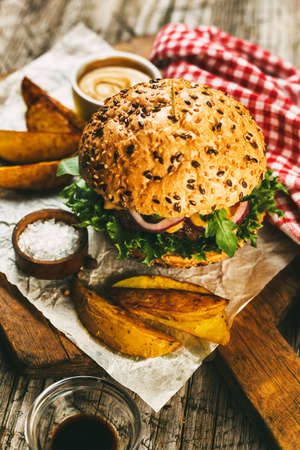 Burger with Cheese and French fries. Fast food. Toned image.の写真素材