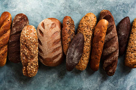 Different types fresh bread on a blue background. Top viewの写真素材