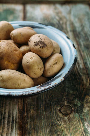 Raw potatoes in a bowlの写真素材