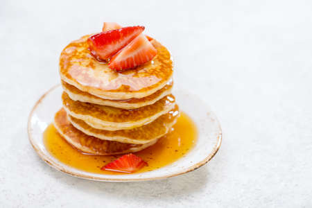 Homemade pancakes with strawberries on a light background with copy space.の写真素材