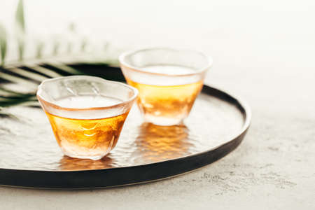 Two glass cups of freshly brewed tea on a trayの写真素材