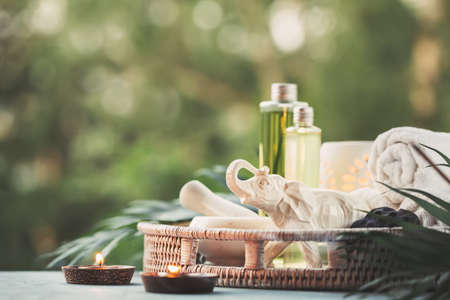 Beautiful composition with natural cosmetic, towels and burning candles.の写真素材