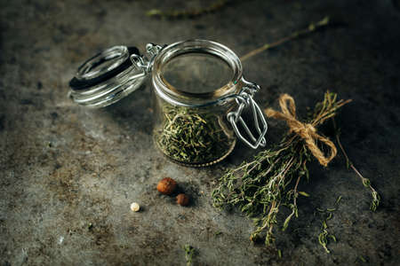 Dried thyme in a glass jarの写真素材