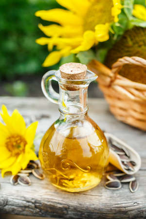 A small glass jug with fresh sunflower oil.の写真素材