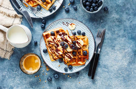 Delicious homemade waffles with banana, chocolate and fresh blueberries. Top viewの写真素材