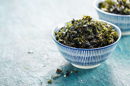 Healthy Japanese bowl of seaweed with sesame and sea salt. Food background with copy space.の写真素材