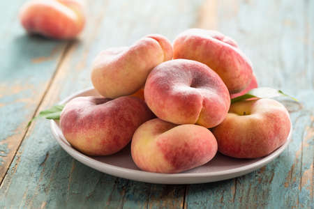 Ripe fig peaches on a plate. Selective focus.の写真素材