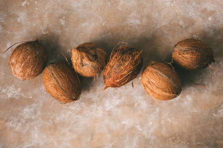 Pile of coconuts, top view. Food background with copy space. Toned imageの写真素材