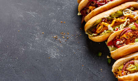 Different Hot dogs with a sausage on a fresh rolls. Food background with copy spaceの写真素材