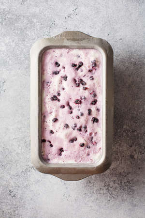 Ice cream with blueberries in a metal container. Top view.