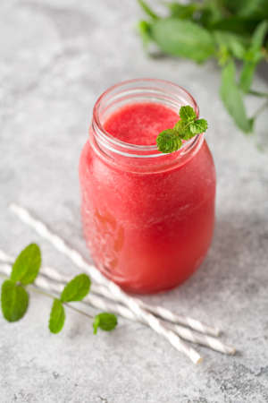 Refreshing summer drink of watermelon with mint and ice in a jar. Shallow depth of fieldの写真素材