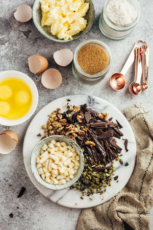 Ingredients for home baking with chocolate. Flour, sugar, eggs, butter and nuts. Top viewの写真素材