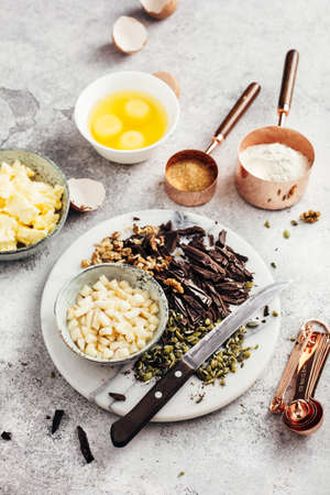 Baking tools and Ingredients for home Baking with Chocolate. Flour, sugar, eggs, butter and nuts. Selective focus.の写真素材