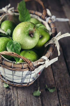 Fresh Green Apples on a rustic wooden background, close up.の写真素材