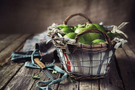Basket with apples on a dark wooden backgroundの写真素材