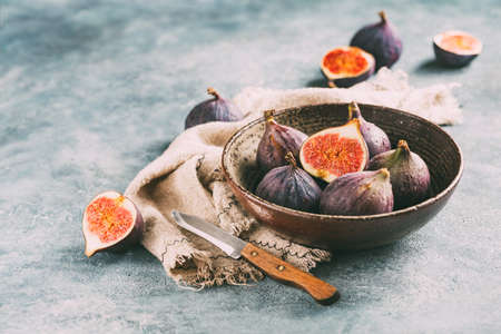 Fresh figs and cut figs in a bowl.の写真素材