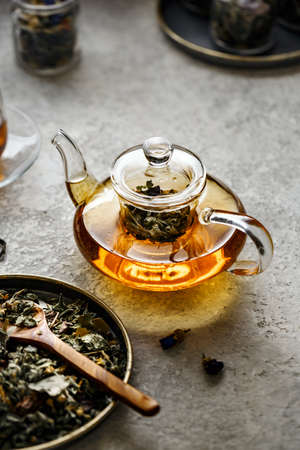 Glass teapot with useful herbal tea.の写真素材