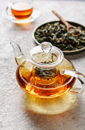 Glass teapot of freshly made herbal tea.の写真素材