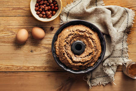 Homemade cake with nuts on a wooden background. Top view.