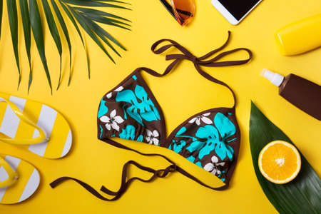 Beach accessories on yellow background.の写真素材