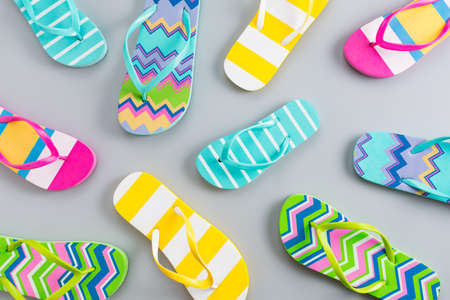 Colorful flip flops on grey background.の写真素材