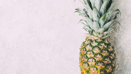 Ripe pineapple on grey textured background.の写真素材