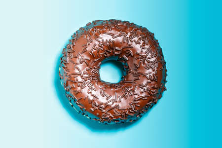 Donuts with chocolate glaze on a blue background.の写真素材