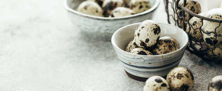 Close-up view of raw quail eggs in a bowls. Farm product. Copy space.の写真素材