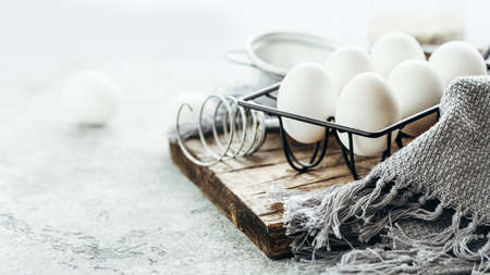Fresh chicken eggs for cooking and a whisk. Selective focusの写真素材