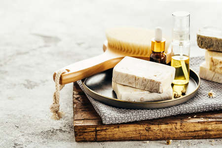 Spa composition with natural homemade soap, towels and aroma oil. Selective focus.