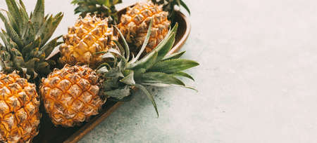 Ripe Thai pineapples on a wooden tray. Tropical theme.の写真素材