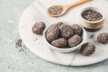 Healthy energy balls made from dried fruits covered with Chia seeds.の写真素材