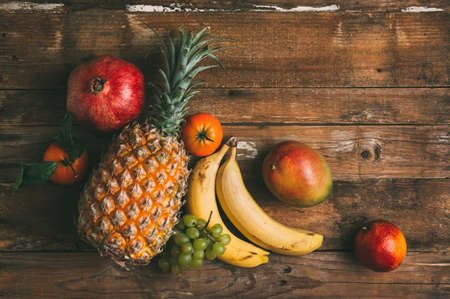 Ripe fruit on a wooden backgroundの写真素材