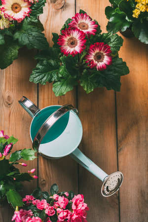 Watering can with flowers.