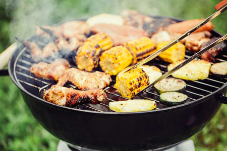 Chicken meats and vegetables on the grillの写真素材