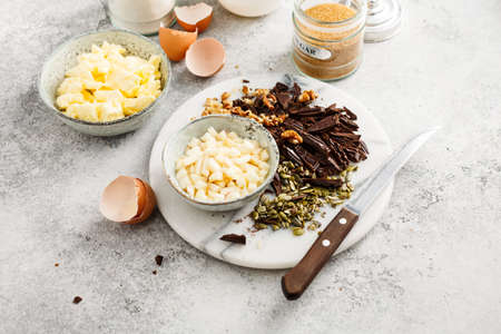 Baking tools and Ingredients for home Baking with Chocolate. Flour, sugar, eggs, butter and nuts.の写真素材
