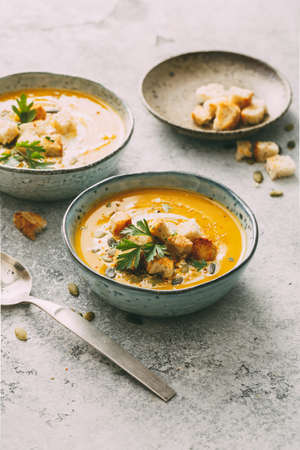 Pumpkin soup in a bowl with croutonsの写真素材