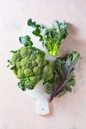 Broccoli and Kale leaves on a marble boardの写真素材