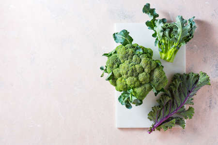 Broccoli and Kale leaves on a marble board.の写真素材