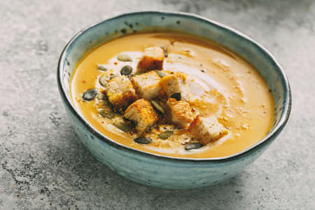 Homemade pumpkin soup in a bowl with croutonsの写真素材