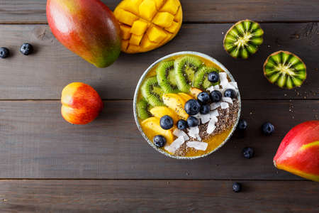 Peach smoothie bowl with kiwi fruitの写真素材