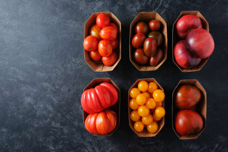 Organic Different Tomatoes on a dark background with copy space, Clean eating. Top view.の写真素材