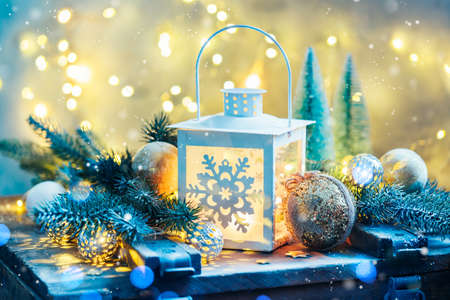 Christmas lantern with festive decoration and bokeh lights.の写真素材