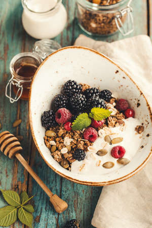 Homemade granola with raspberries and blackberries.の写真素材