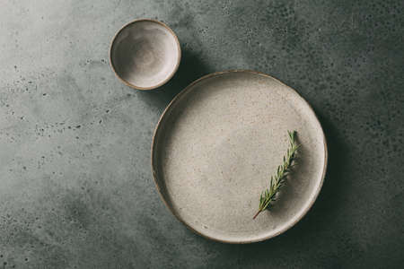 Flat ceramic plate with rosemary.の写真素材