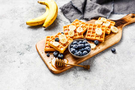 Delicious homemade waffles with banana and blueberries.の写真素材